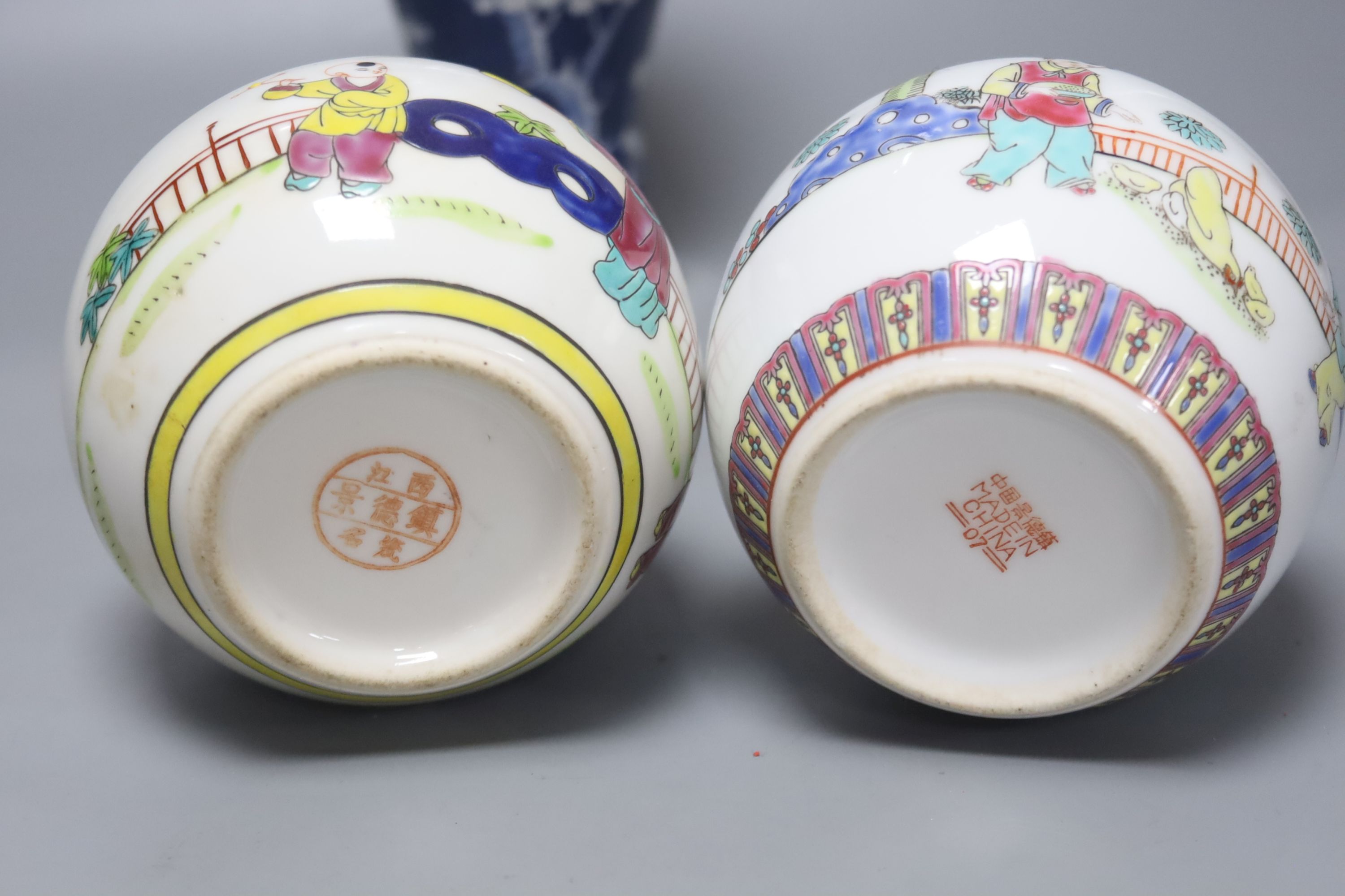 A Chinese blue and white vase and cover, a pair of famille rose jars and covers and two other jars and covers, tallest 27cm